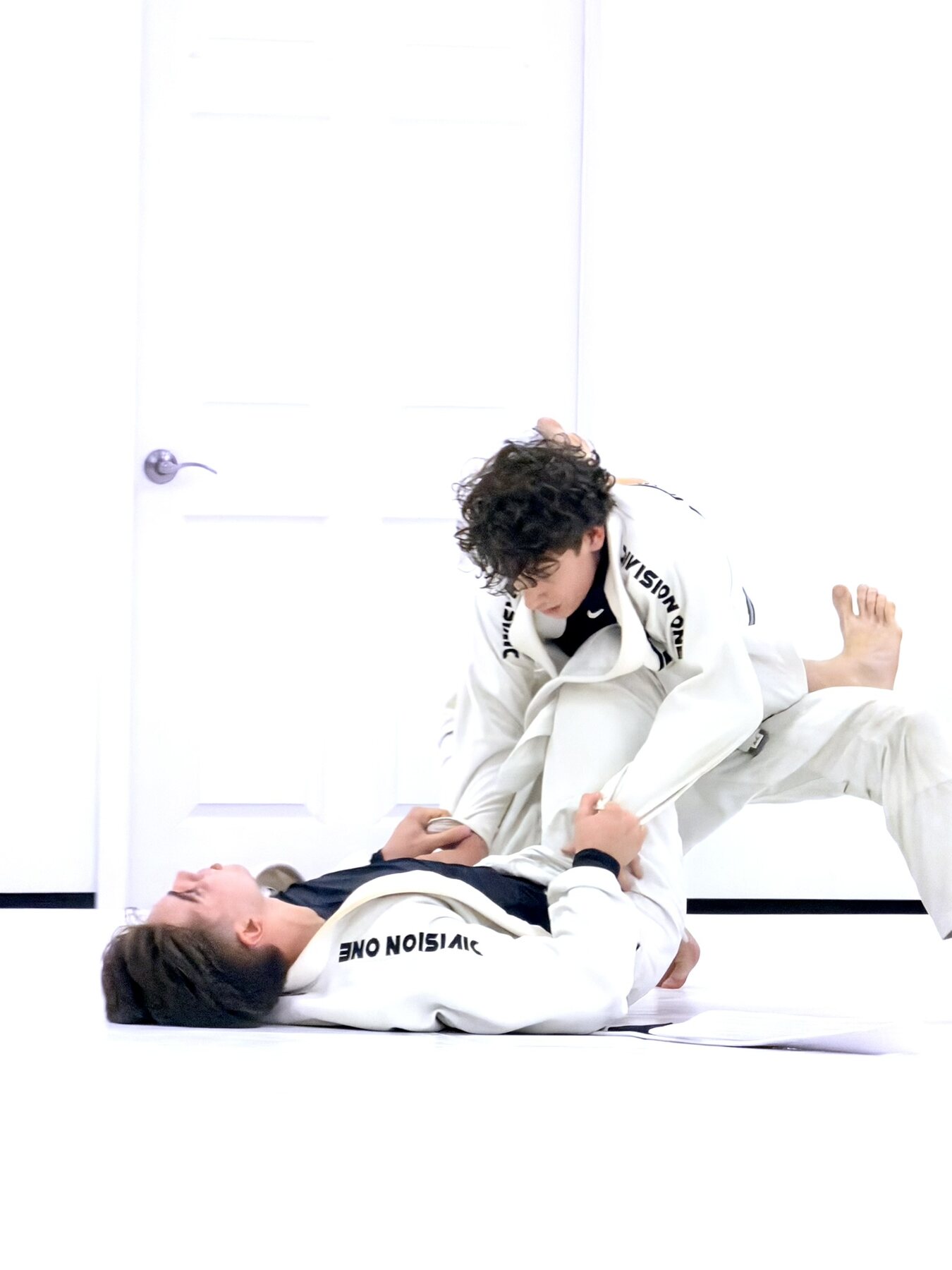Young Brazilian Jiu-Jitsu students training on the mat