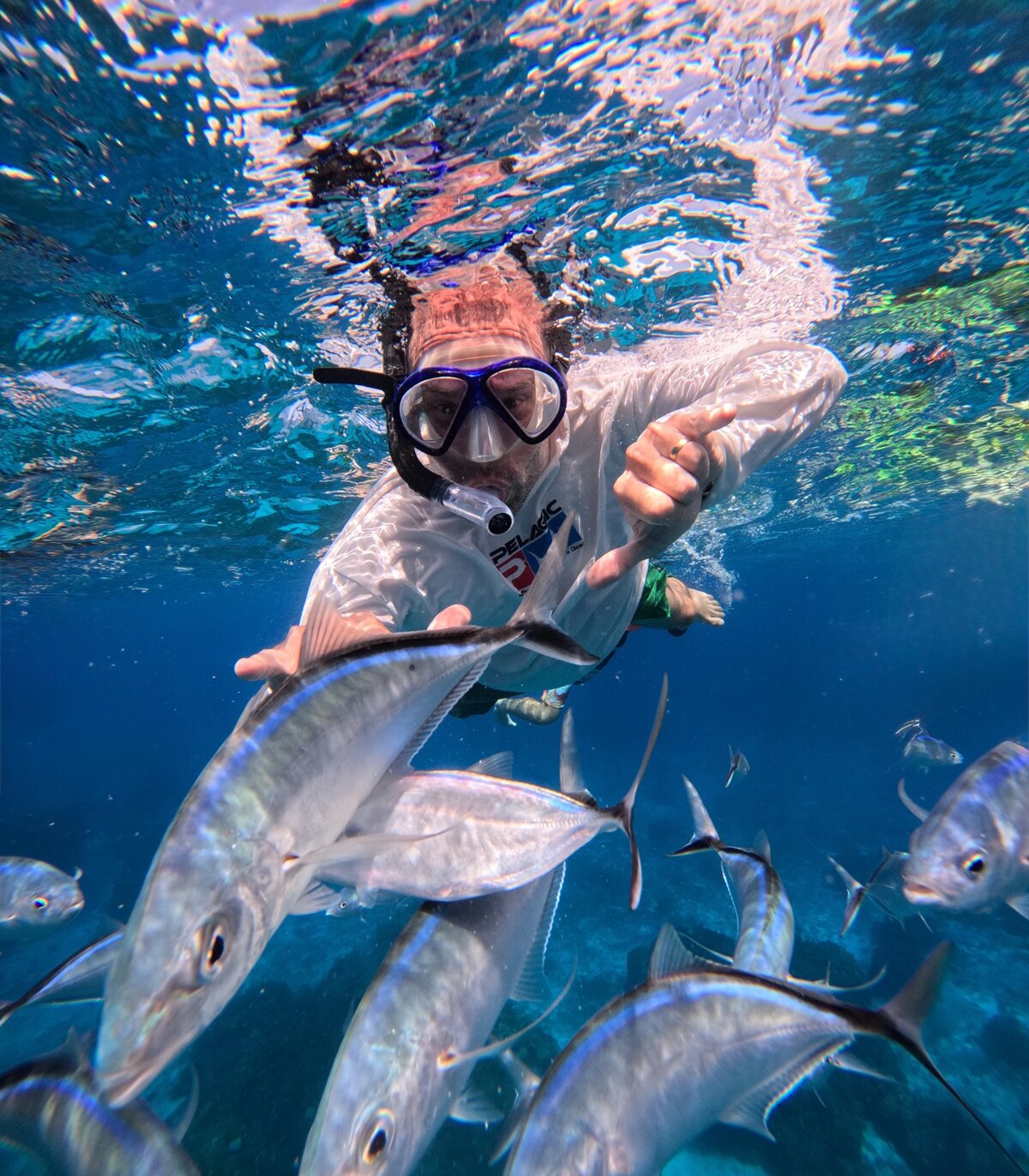Ronnie snorkeling among tropical fish while traveling